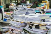 office full of stacks of documents ready for purge shredding
