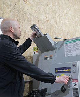 DataShred employee putting a hard drive through a shredder