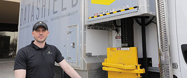 DataShield employee emptying shred bin into shred truck
