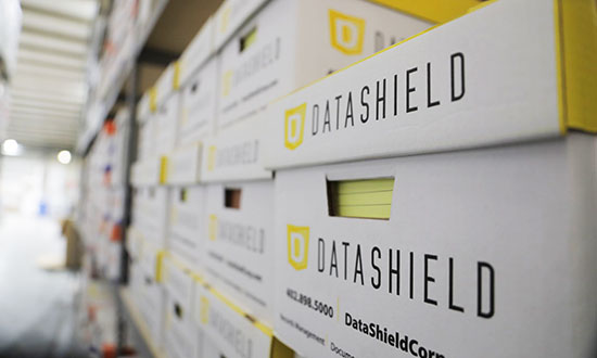 DataShield records storage boxes on a shelf in a warehouse
