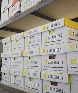 DataShield records storage boxes on a shelf in a warehouse