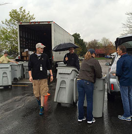 DataShield employees loading bins onto shred truck