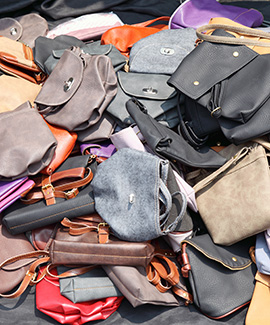 a pile of purses ready for destruction